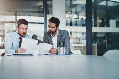 two young professional men meeting around a table